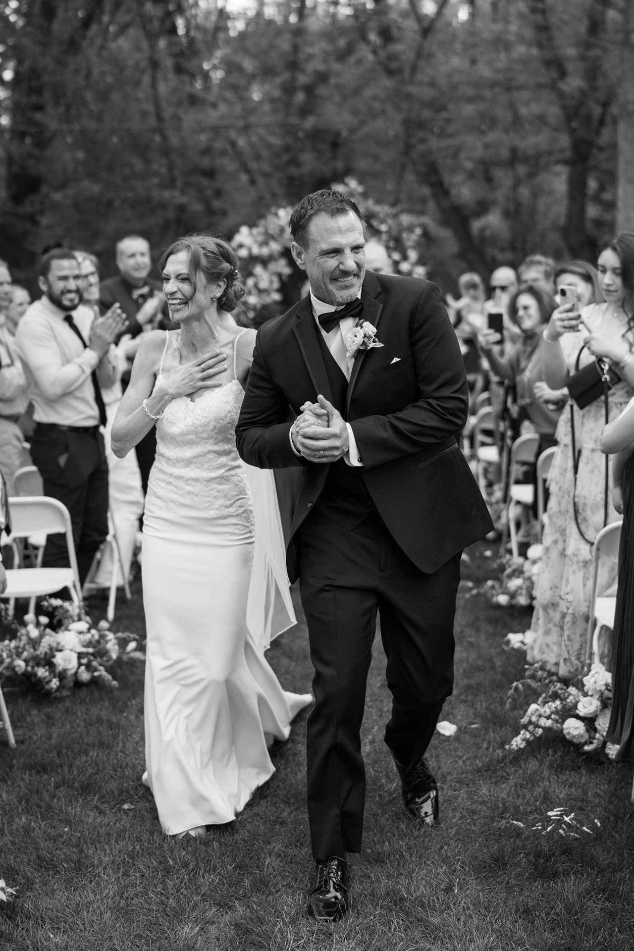 candid photo of bride and groom walking out of wedding ceremony