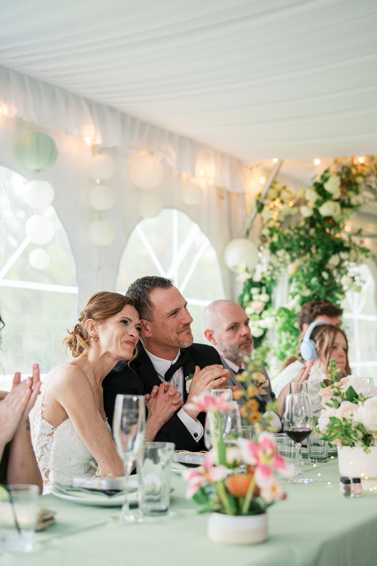 bride and groom listening to speeches