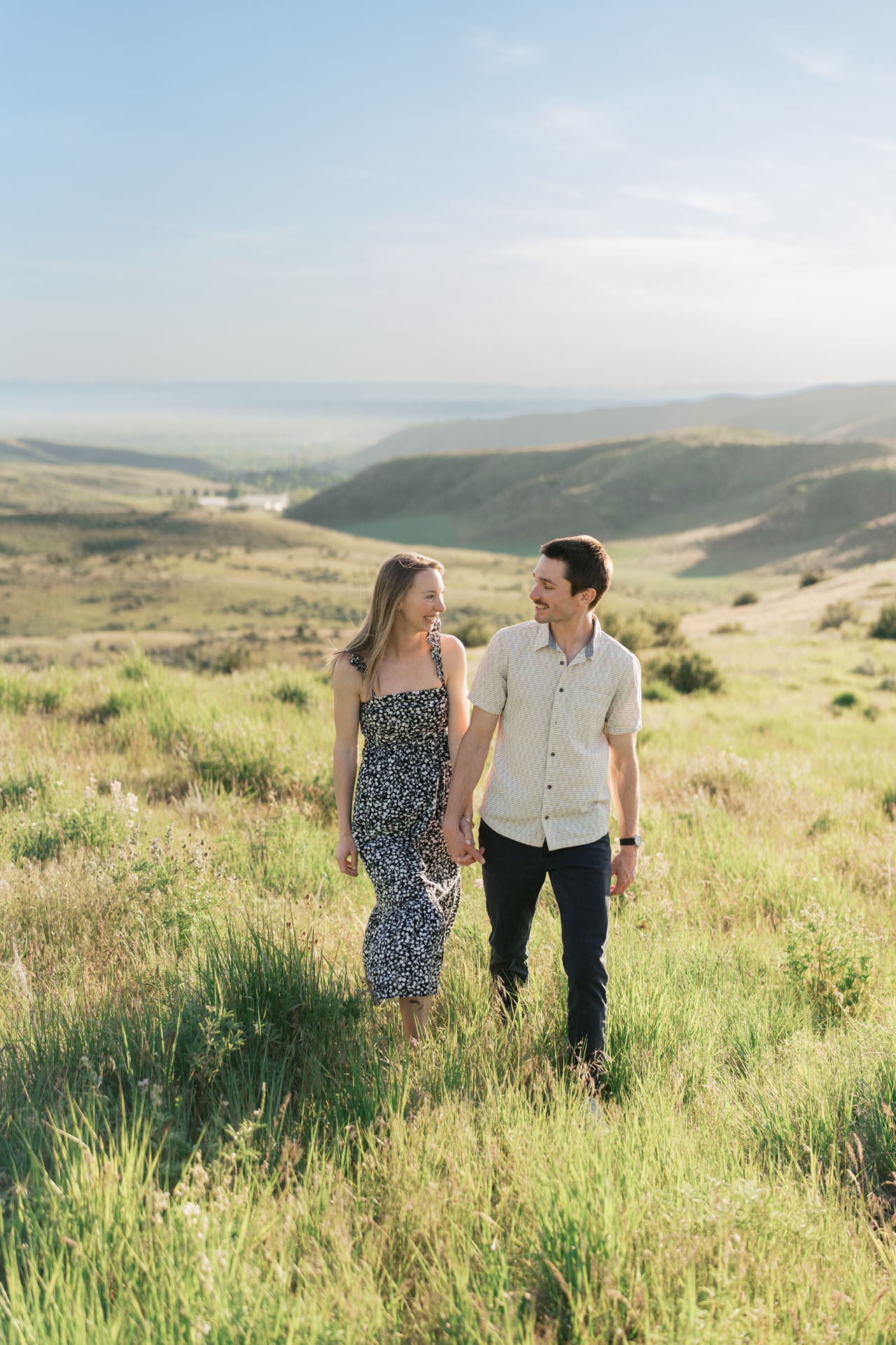 engaged couple walking in Idaho