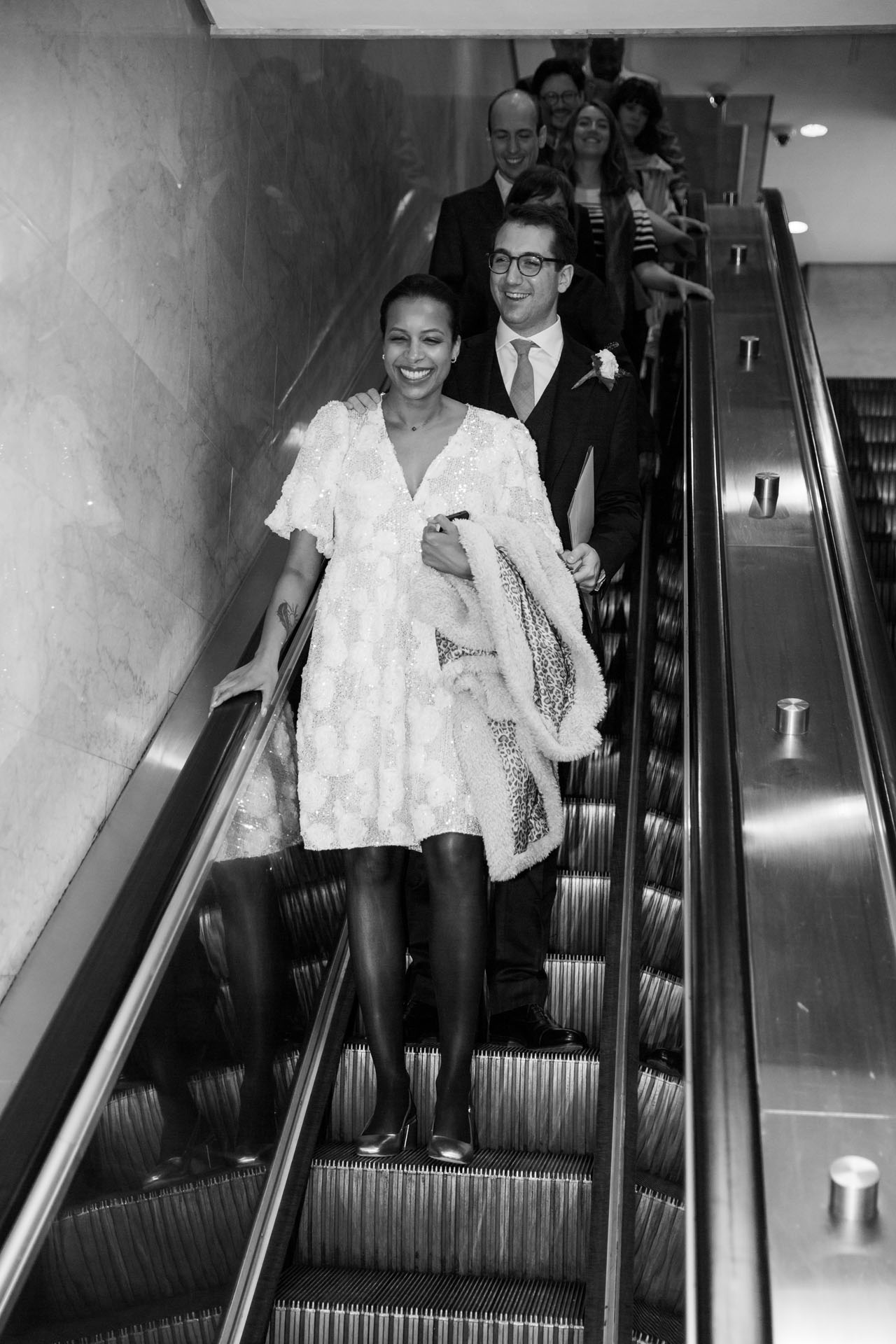 couple riding the elevator down to get married at City Hall in Chicago