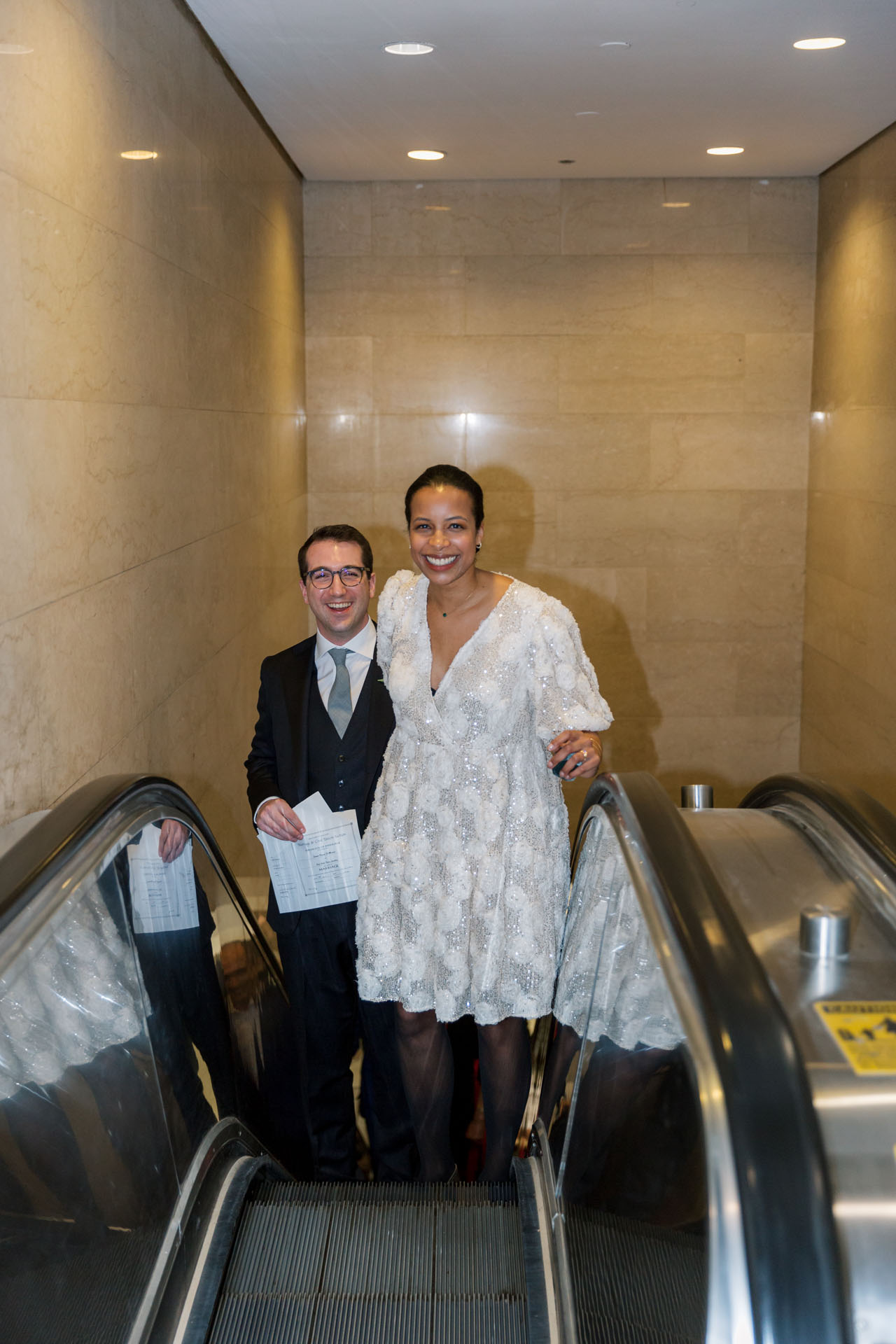 couple taking the elevator up after eloping at City Hall 
