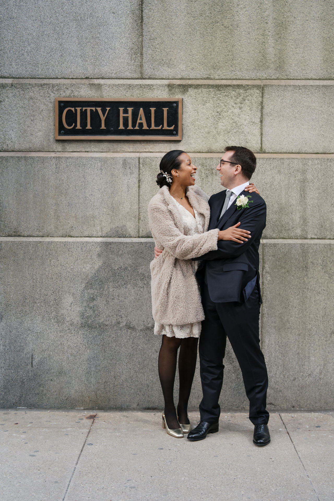 couple in front of the city hall sign in Chicago