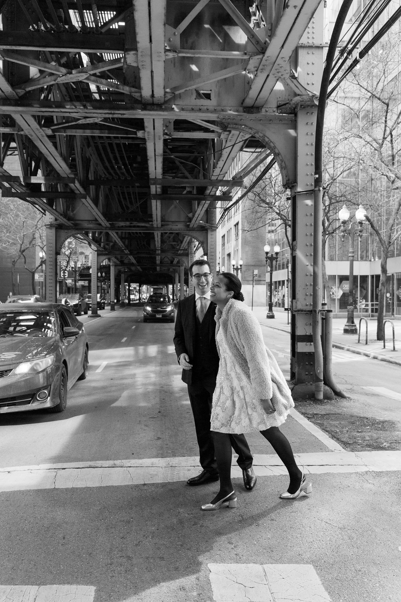 couple walking under the L tracks in Chicago