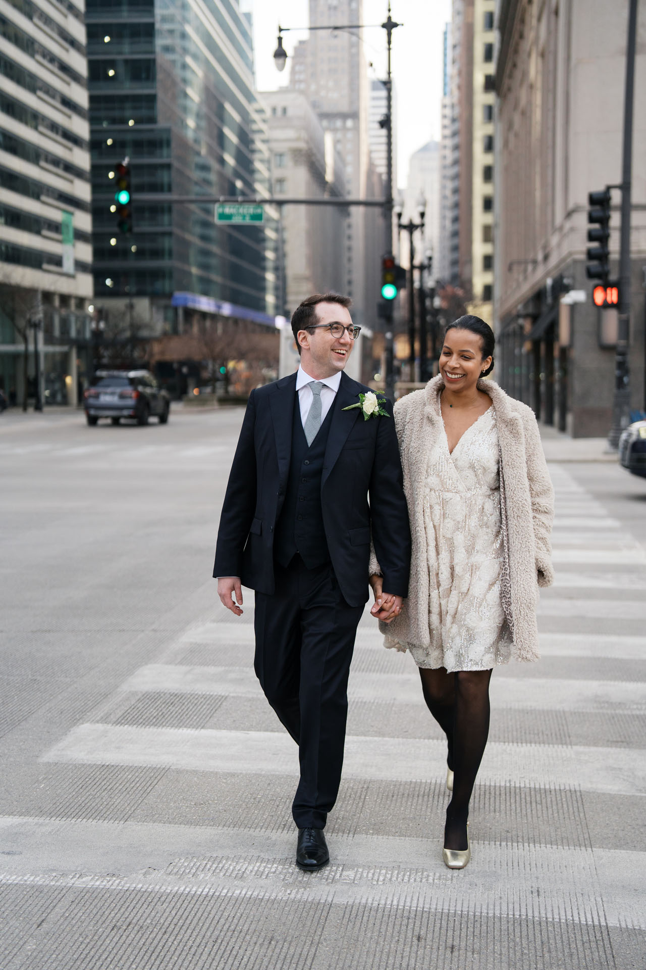 bride and groom holding hands and walking in Chicago