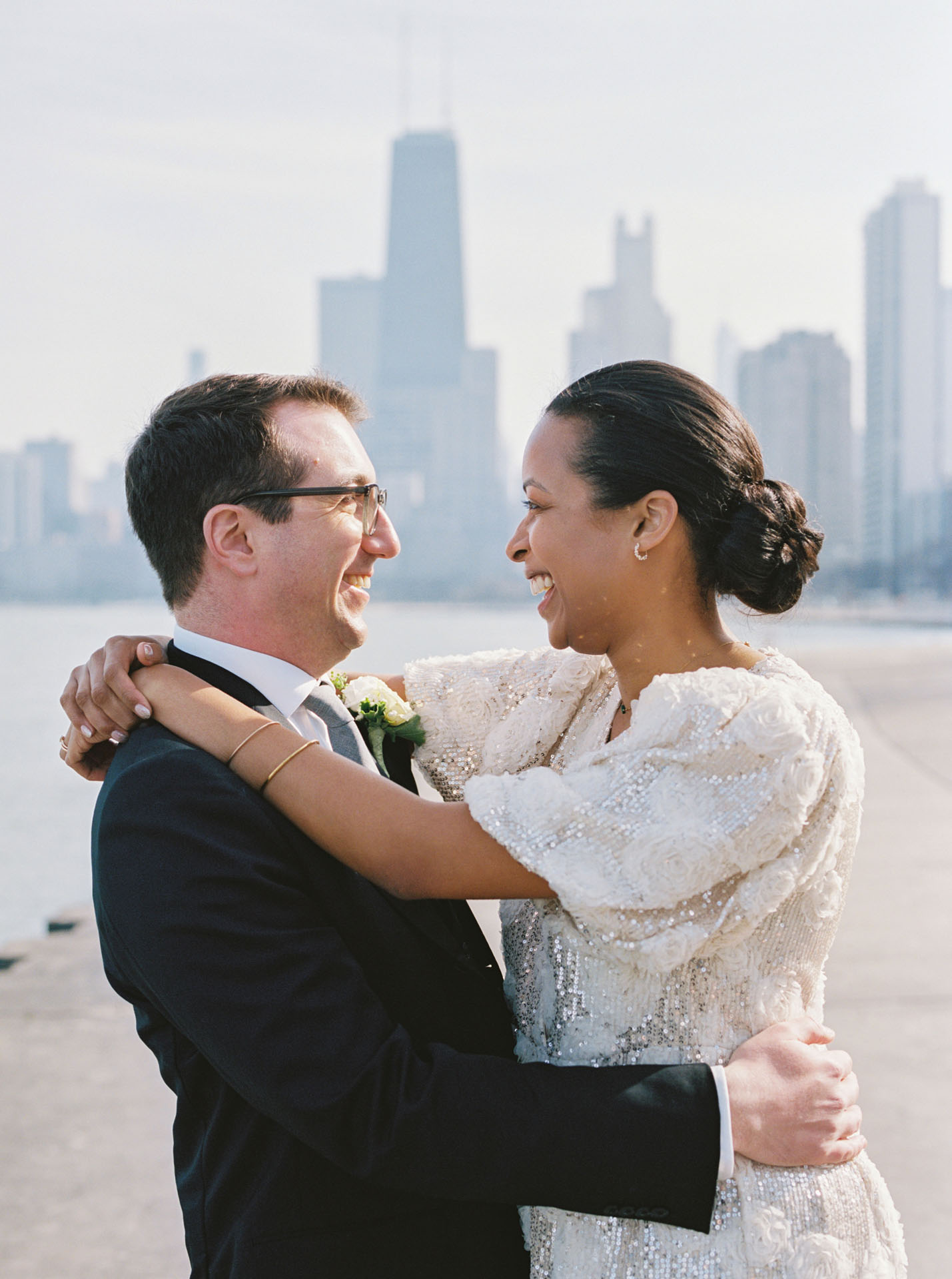 bride and groom smiling at each other