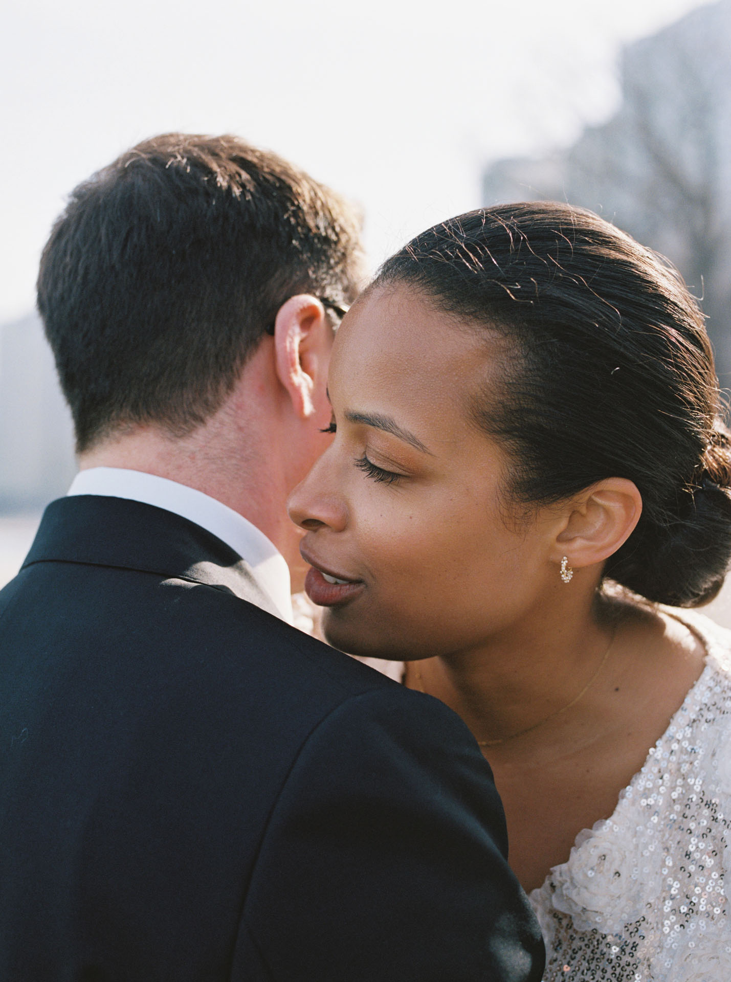 bride whispering into groom's ear