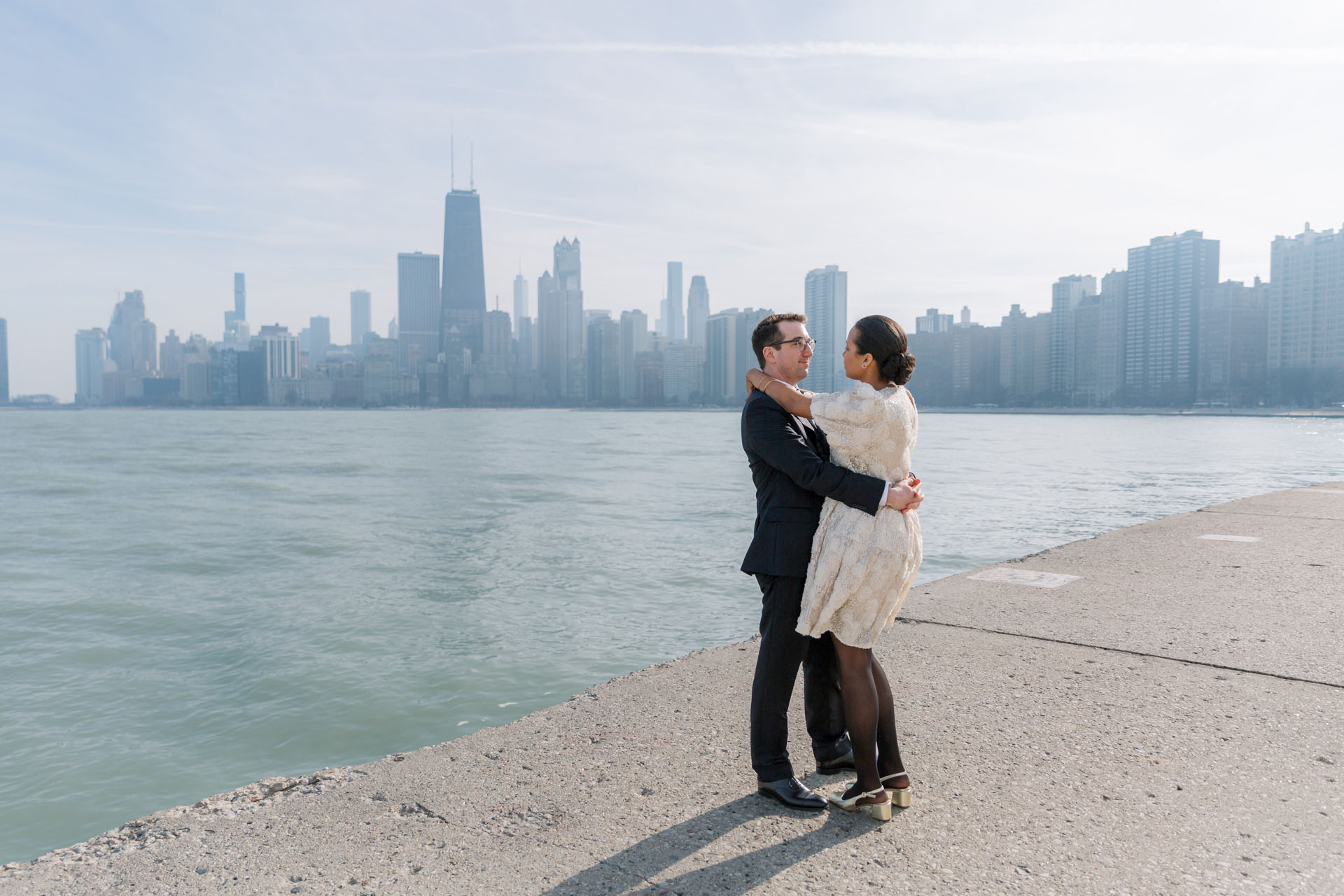 groom and bride with the Chicago skyline behind them