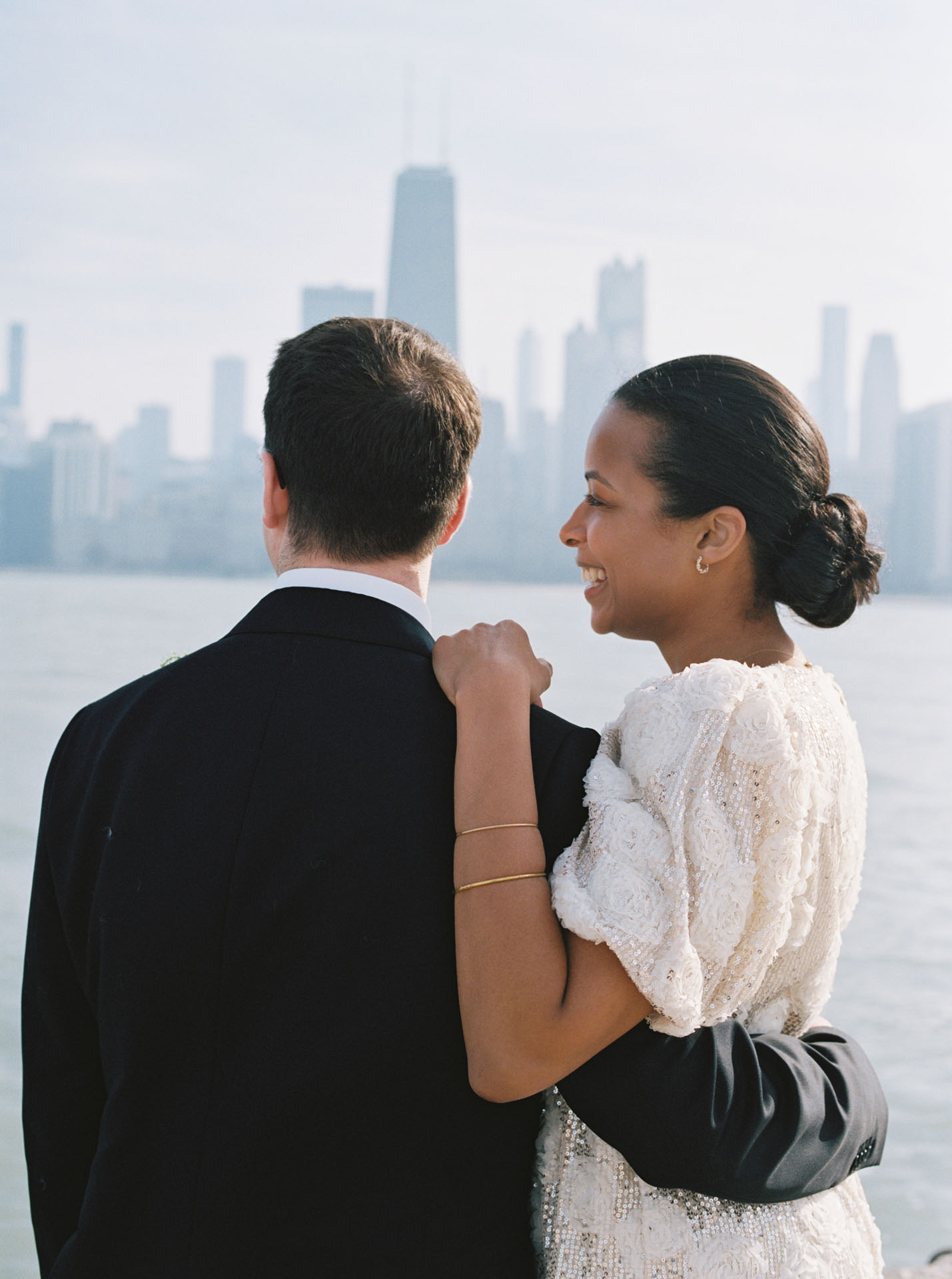 film photograph of bride with arm around groom
