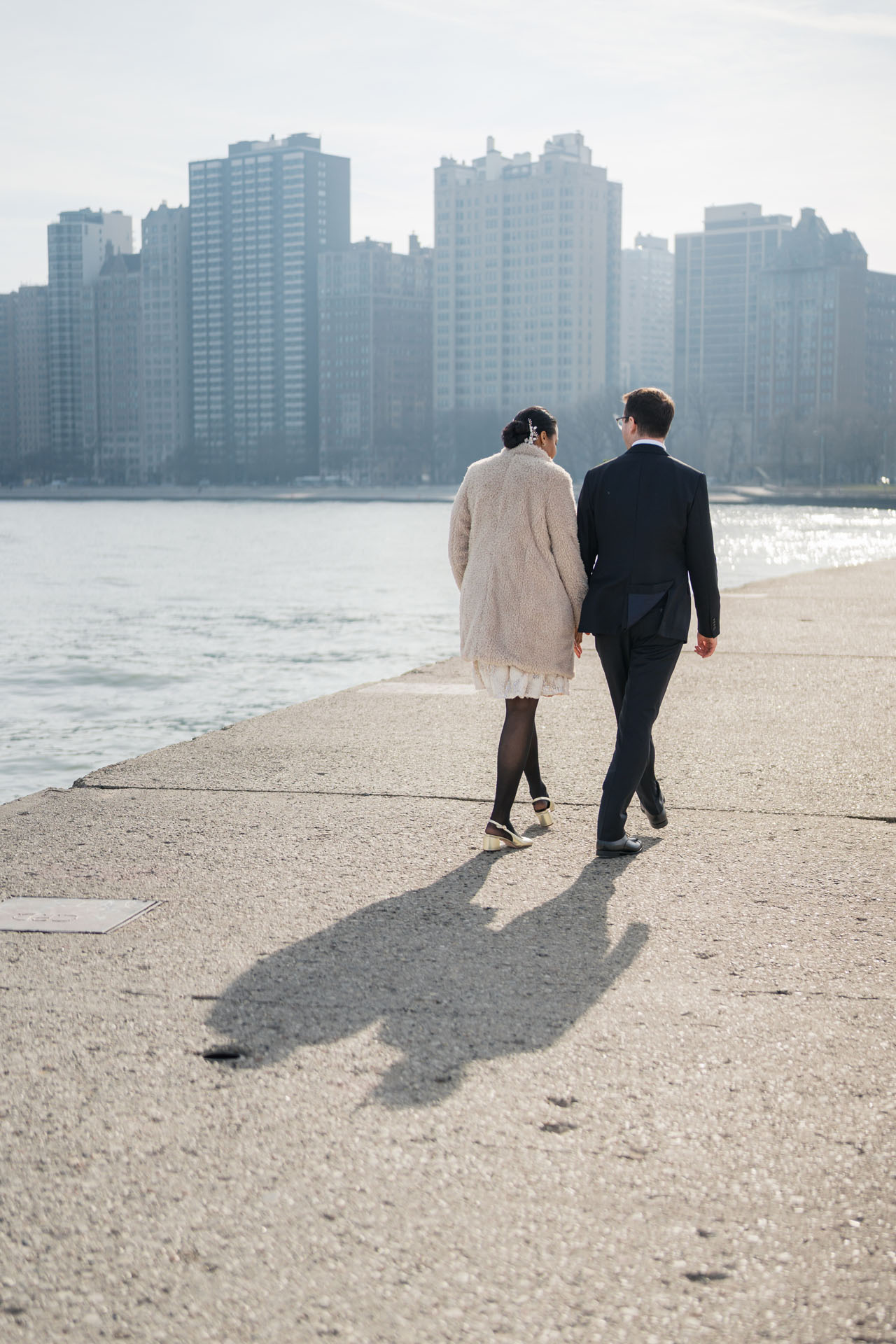 couple walking back to catch a ride to their reception