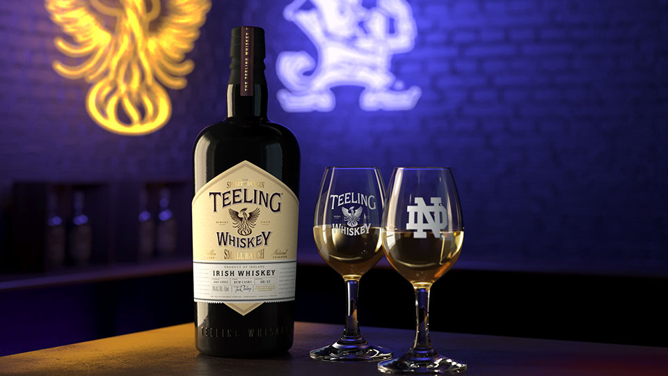Teeling bottle in a bar setting with neon lights in background