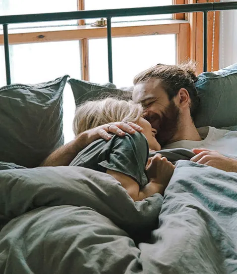 happy couple in bed