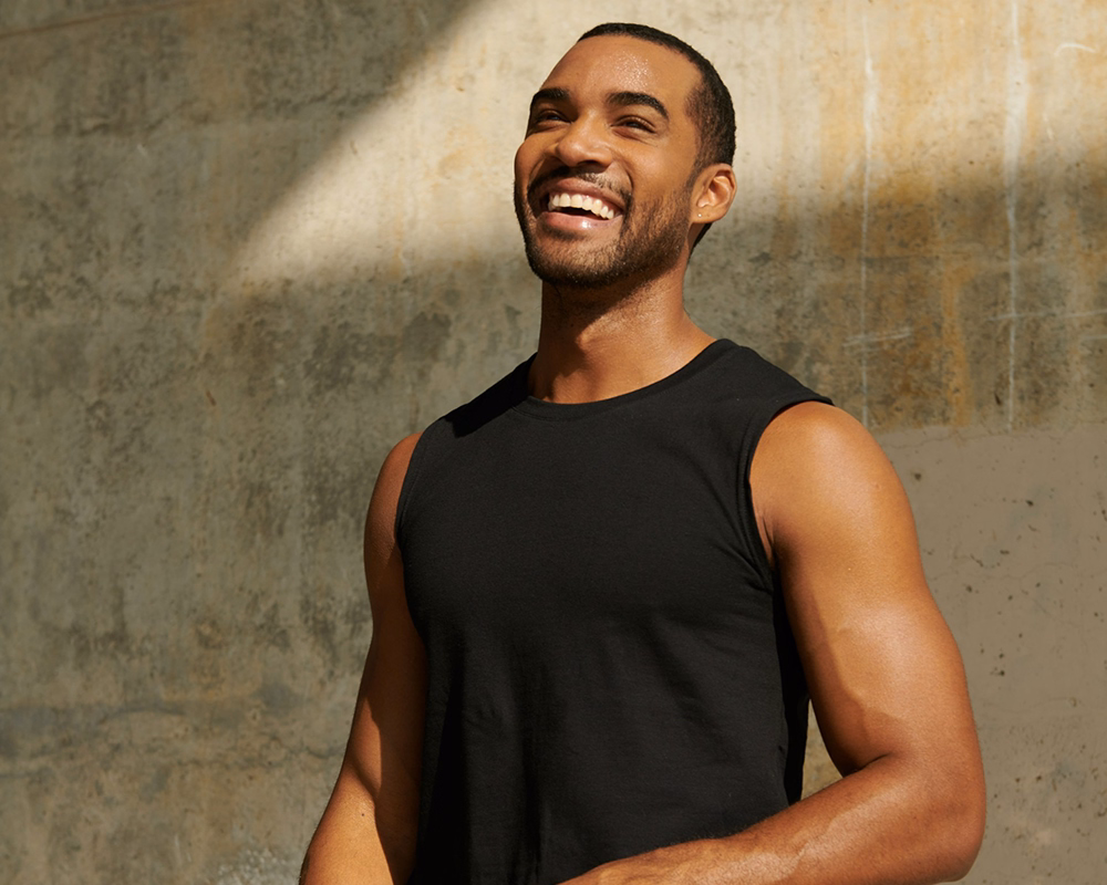 Smiling man in athletic clothing outdoors representing medical weight loss care through Phoenix