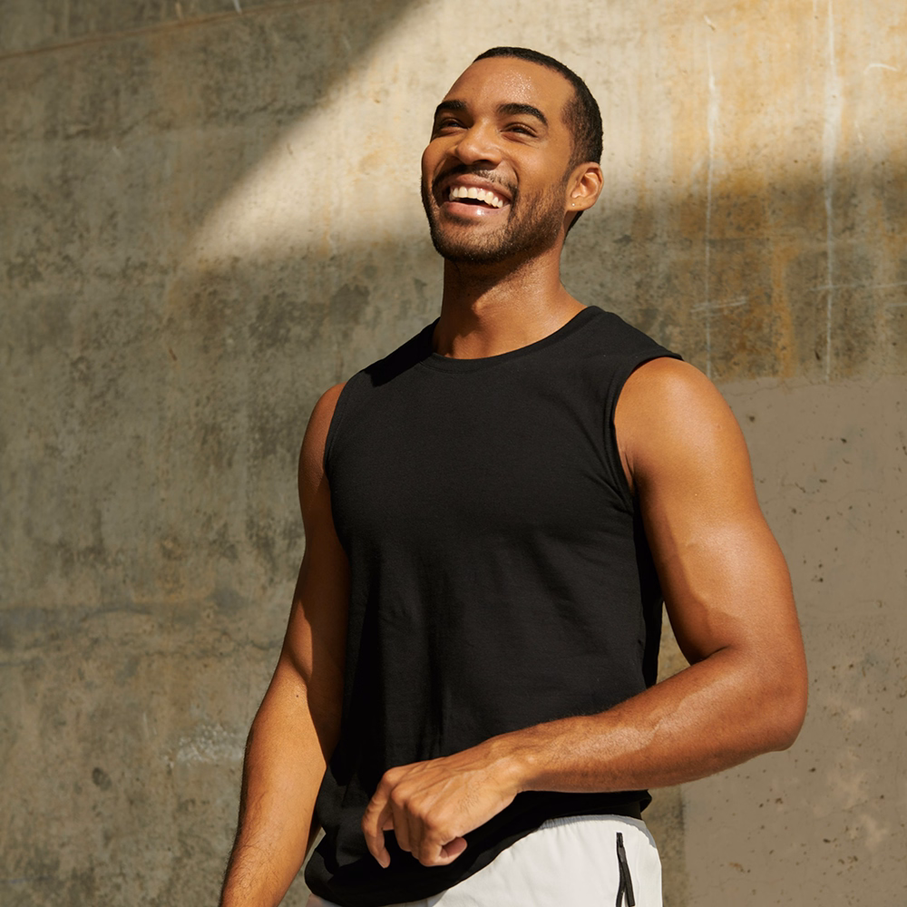 Smiling man in athletic clothing outdoors representing medical weight loss care through Phoenix