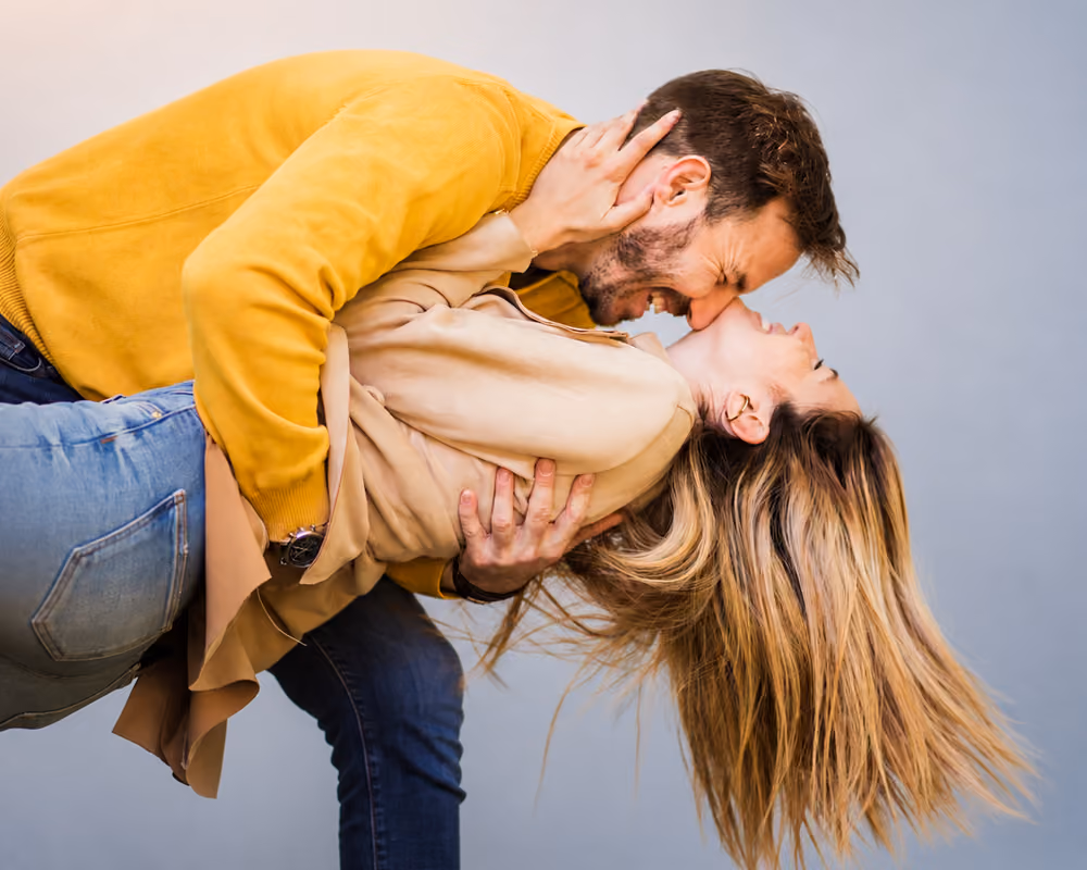 Happy couple embracing and kissing, representing intimacy and erectile dysfunction treatment support from Phoenix.