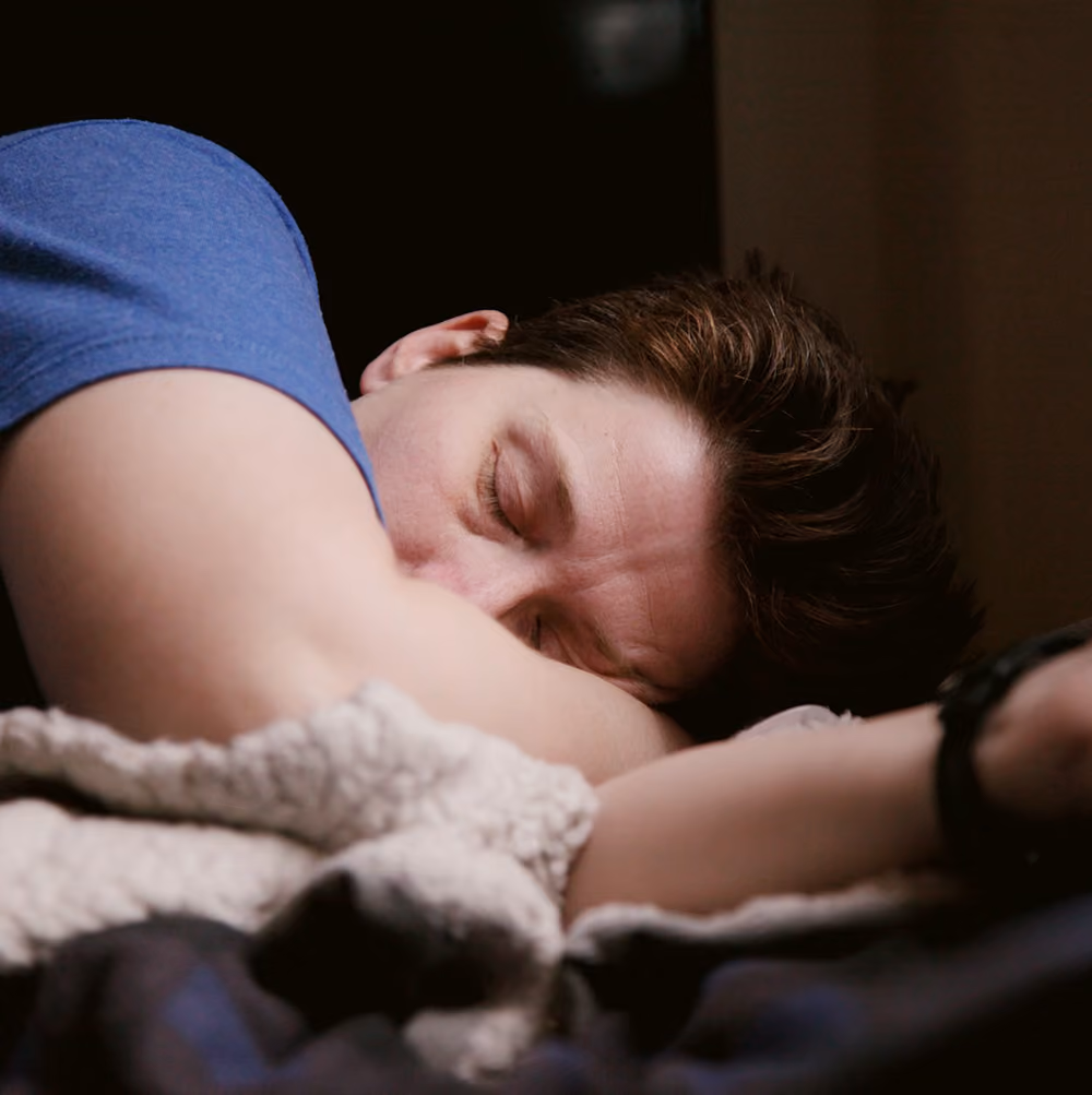 Man waking up refreshed in a bright bedroom