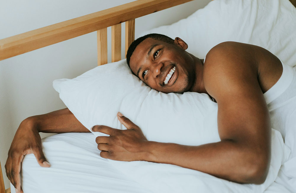 Man sleeping in bed for a Phoenix article about weight loss and sleep apnea