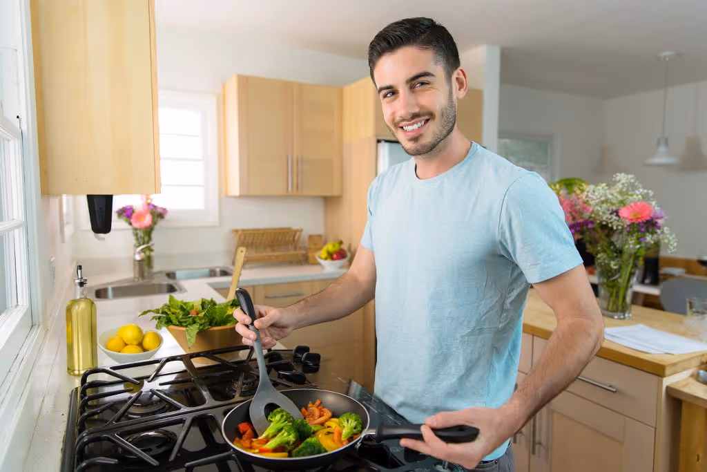 A person cooking some vegetables in the kitchen 