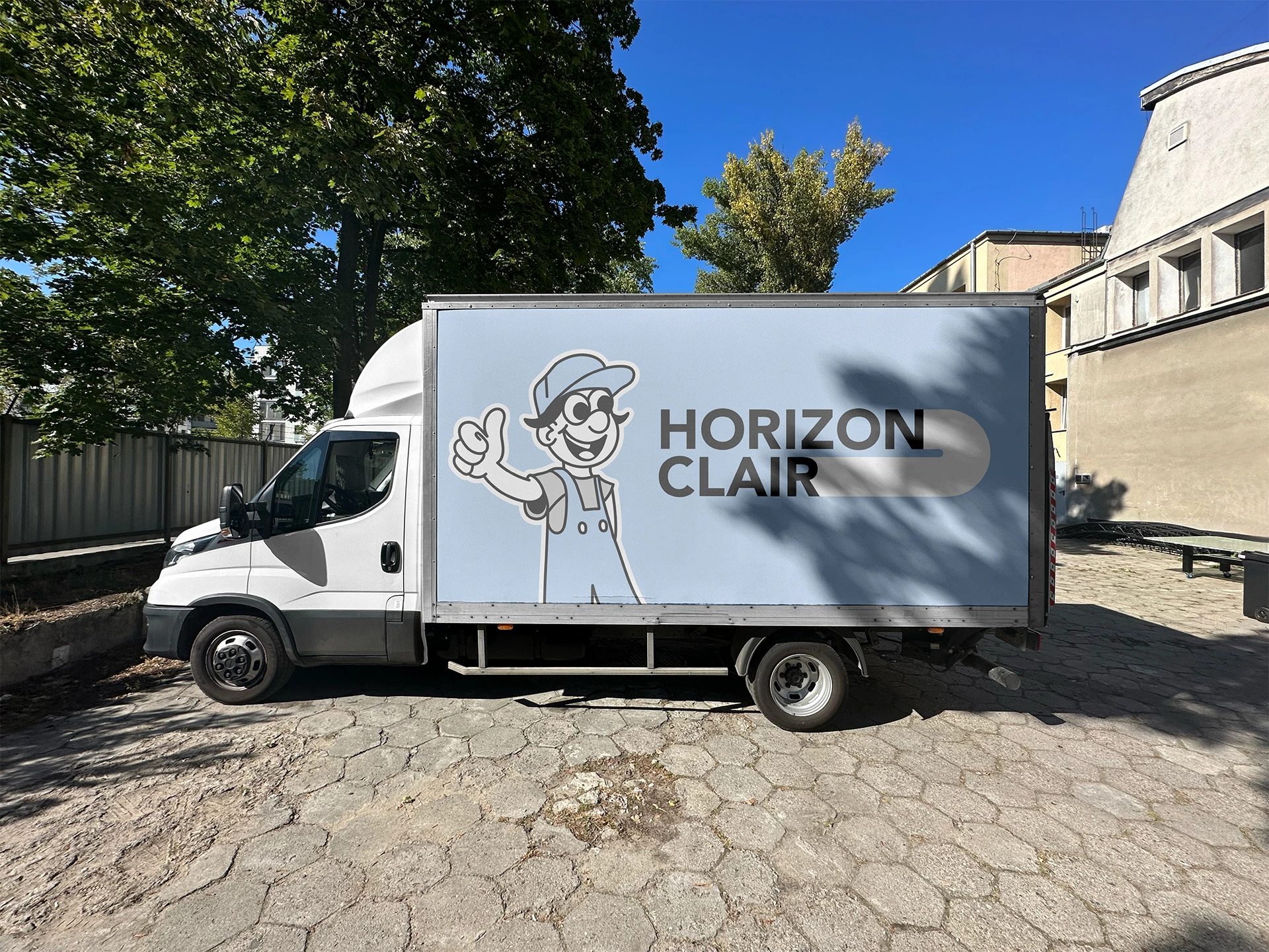 White truck with horizon clair logo on the side with a friendly mascot stiking his thumb up