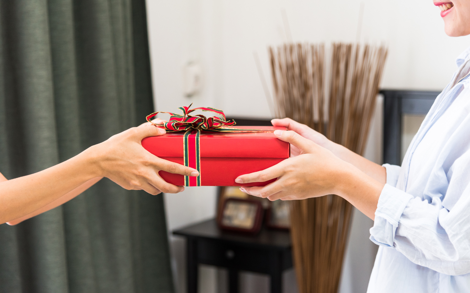 A person receiving a birthday gift, reflecting Princess Polly's dedication to celebrating a birthday milestone within their loyalty program. 