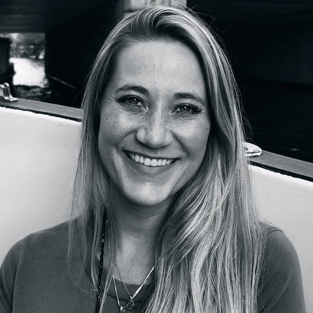 Black and white portrait of Kendra, smiling