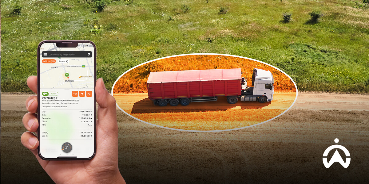 Cartrack vehicle monitoring systems on smartphone tracking red truck on dirt road.