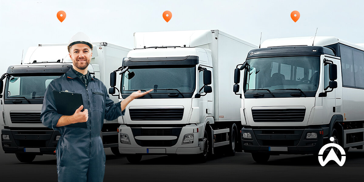 Cartrack fleet tracking with worker in helmet managing parked trucks using clipboard.