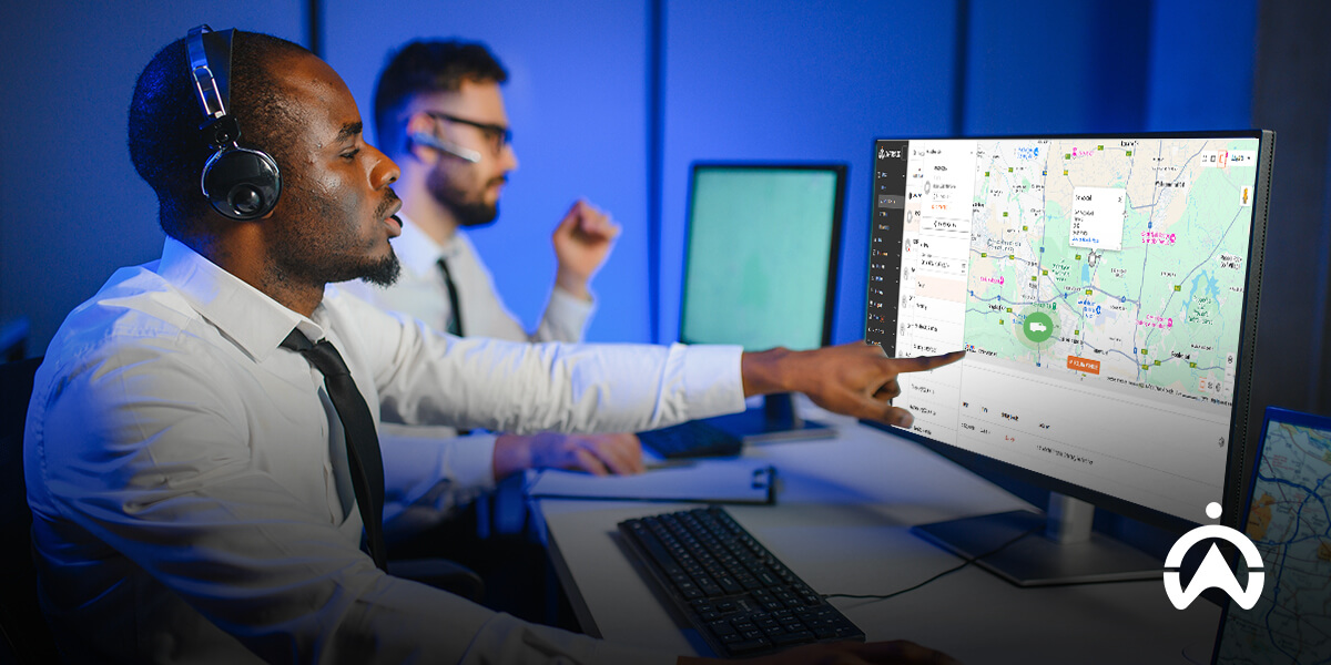 Cartrack GPS tracker vs AirTag comparison shown with headset user pointing at detailed digital map on monitor.