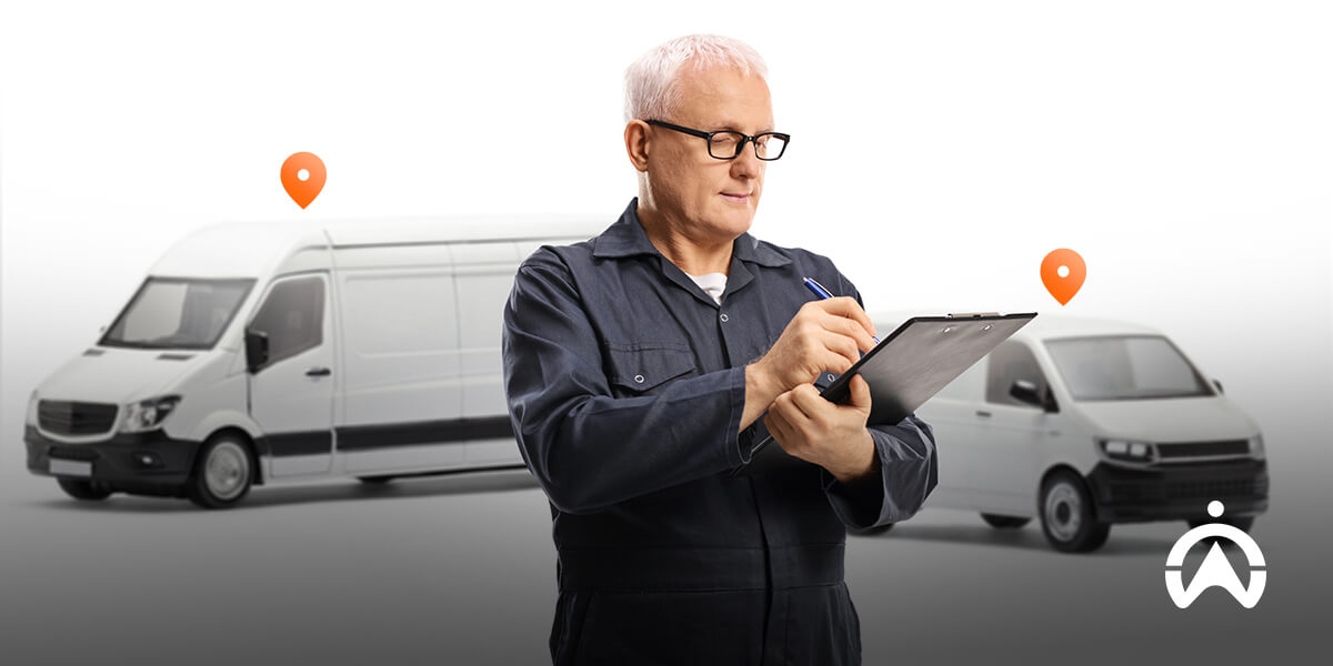 An individual in a work uniform checks a clipboard, with two delivery vans parked in the background and location markers nearby.