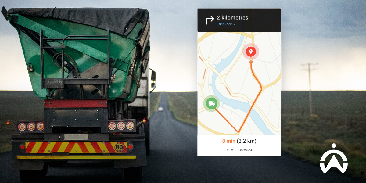 A green dump truck drives on a road; navigation map shows a route of 2 km, estimated arrival in 8 minutes at 10:28 AM.
