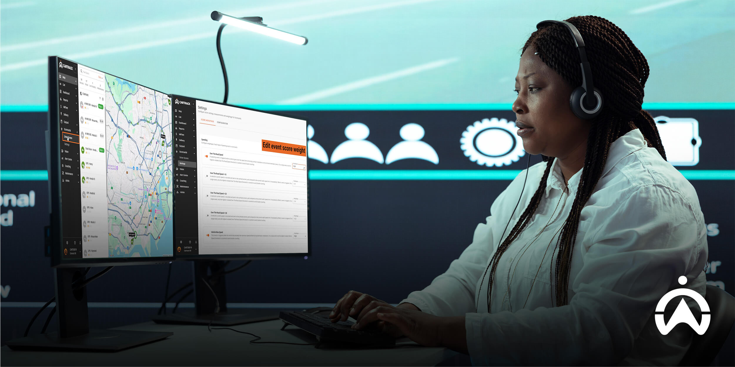 Operator in control room monitoring live tracking dashboard for an insurance approved vehicle tracker.