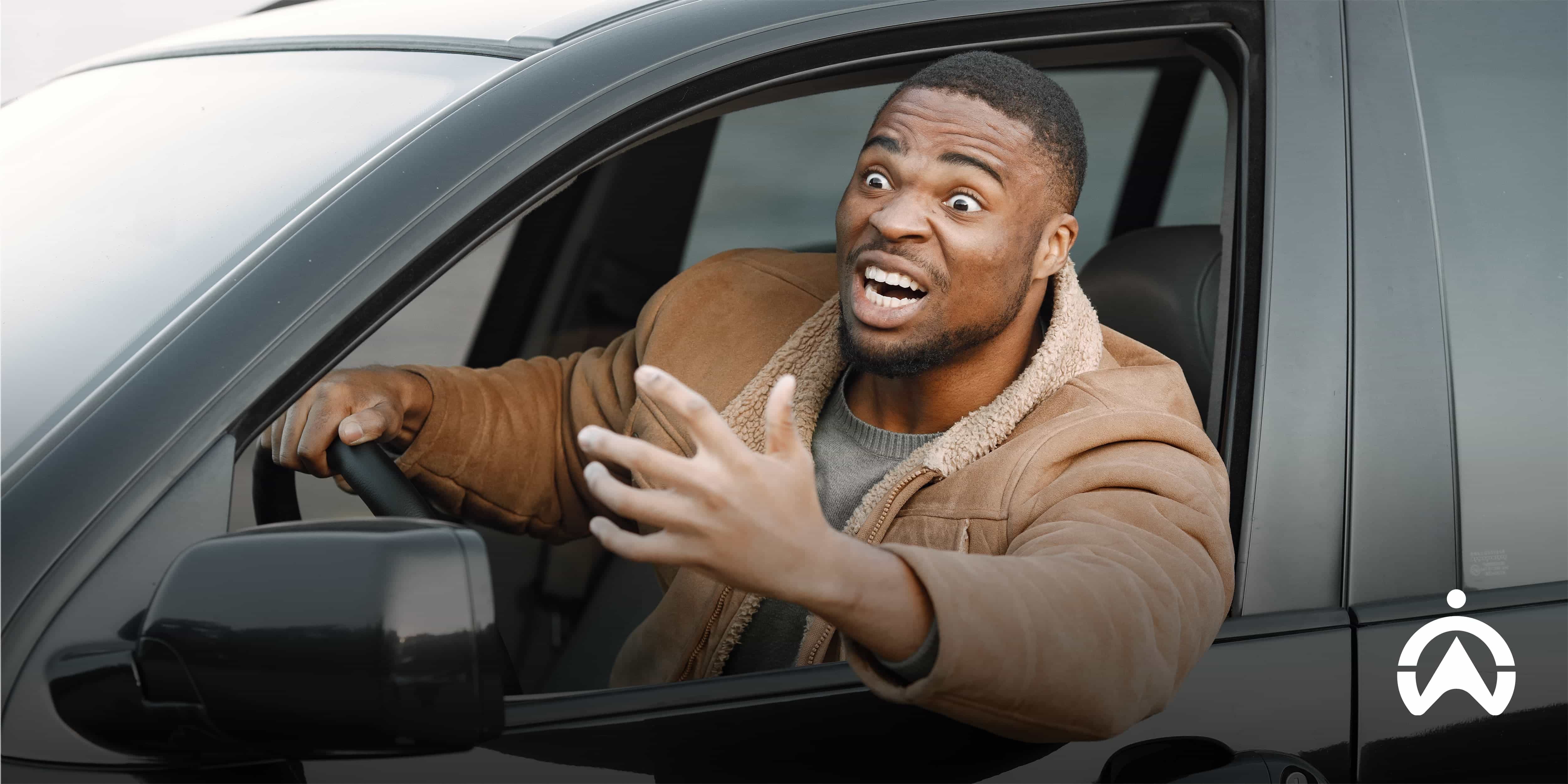 Man gesturing from the driver’s seat during a traffic dispute, showing how to instantly deal with road rage and avoid aggressive driving situations