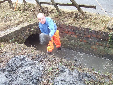 A person in orange pants holding a brushAI-generated content may be incorrect.
