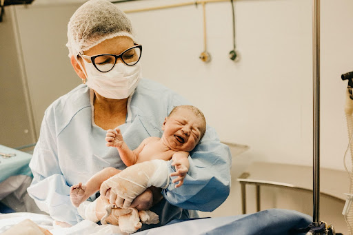 Midwife and newborn baby
