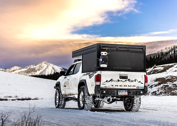 Truck Camper driving through snow