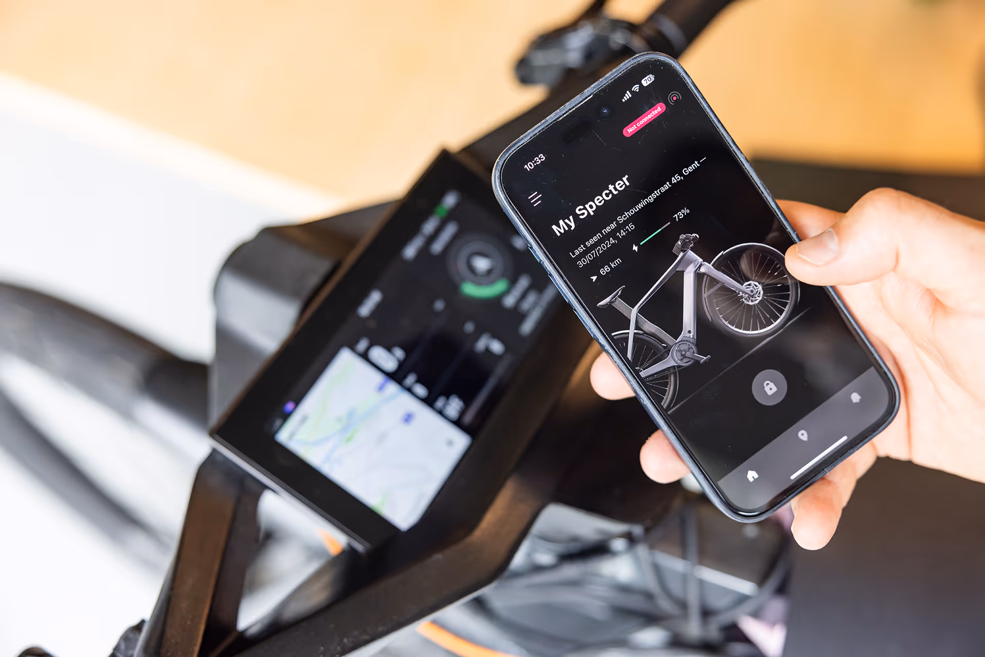 An image of the specter bike with the HUD interface and the mobile app of the specter bike.