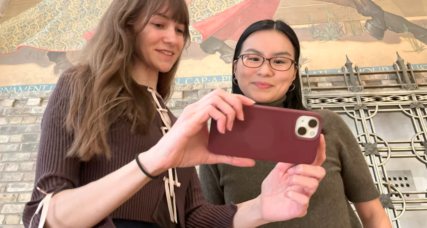 two girls watching on cellphone