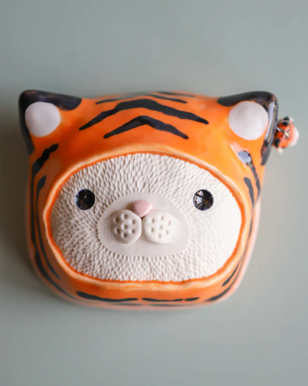 Four corked bear head shaped vases.