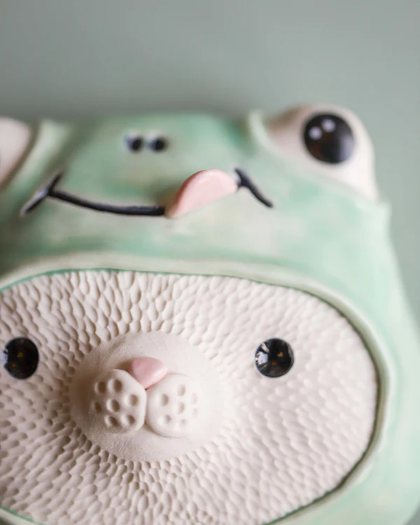 Ten hedgehog shot glasses with various colored glazed interiors.