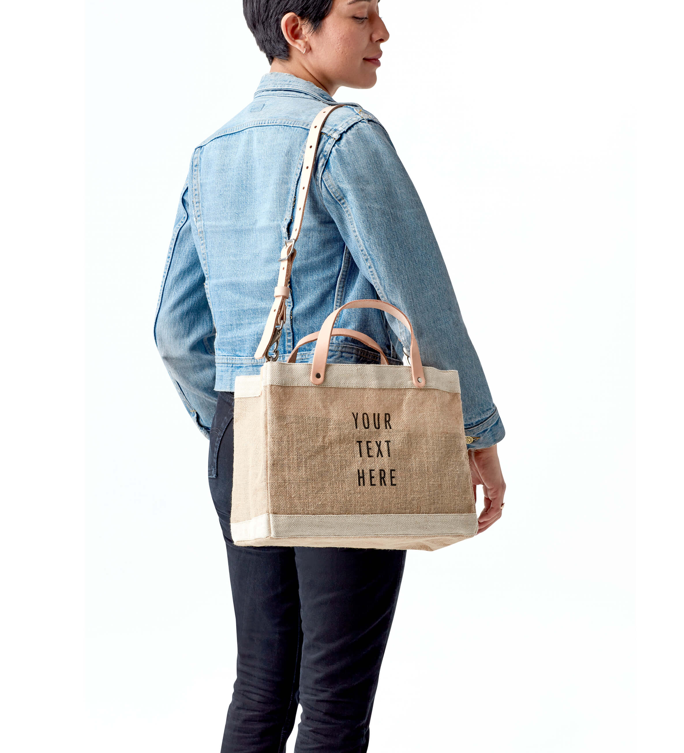 A woman handing a gift bag to an attendee at an event