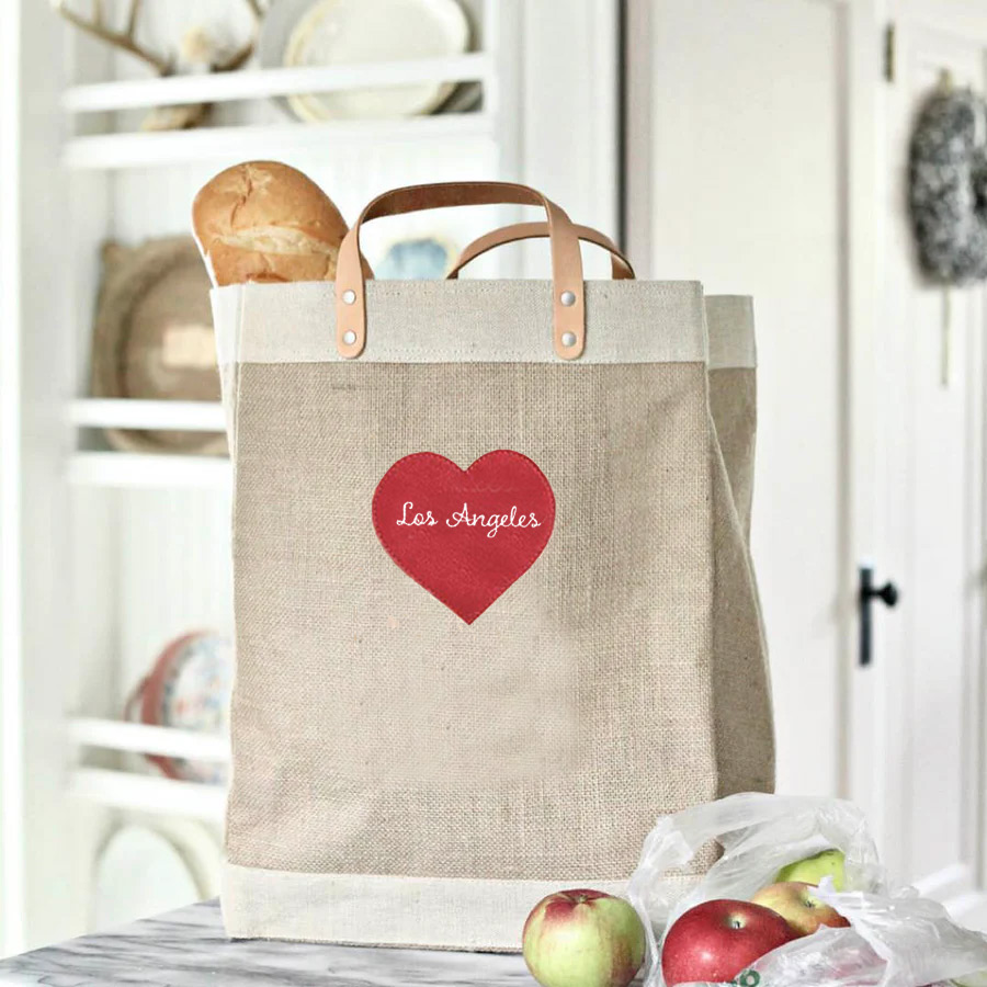 People leaving an event with their market bags