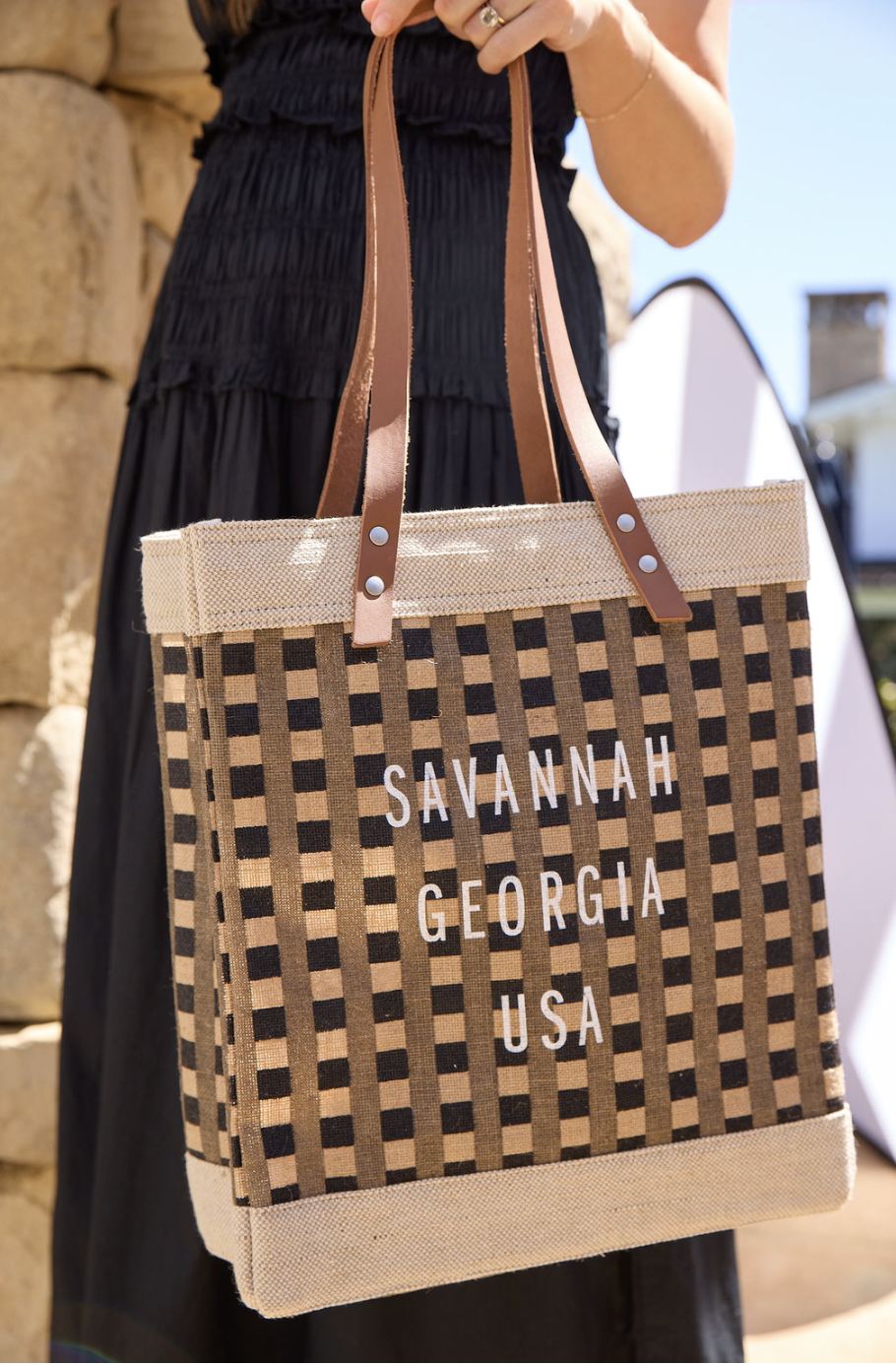 A woman handing a gift bag to an attendee at an event