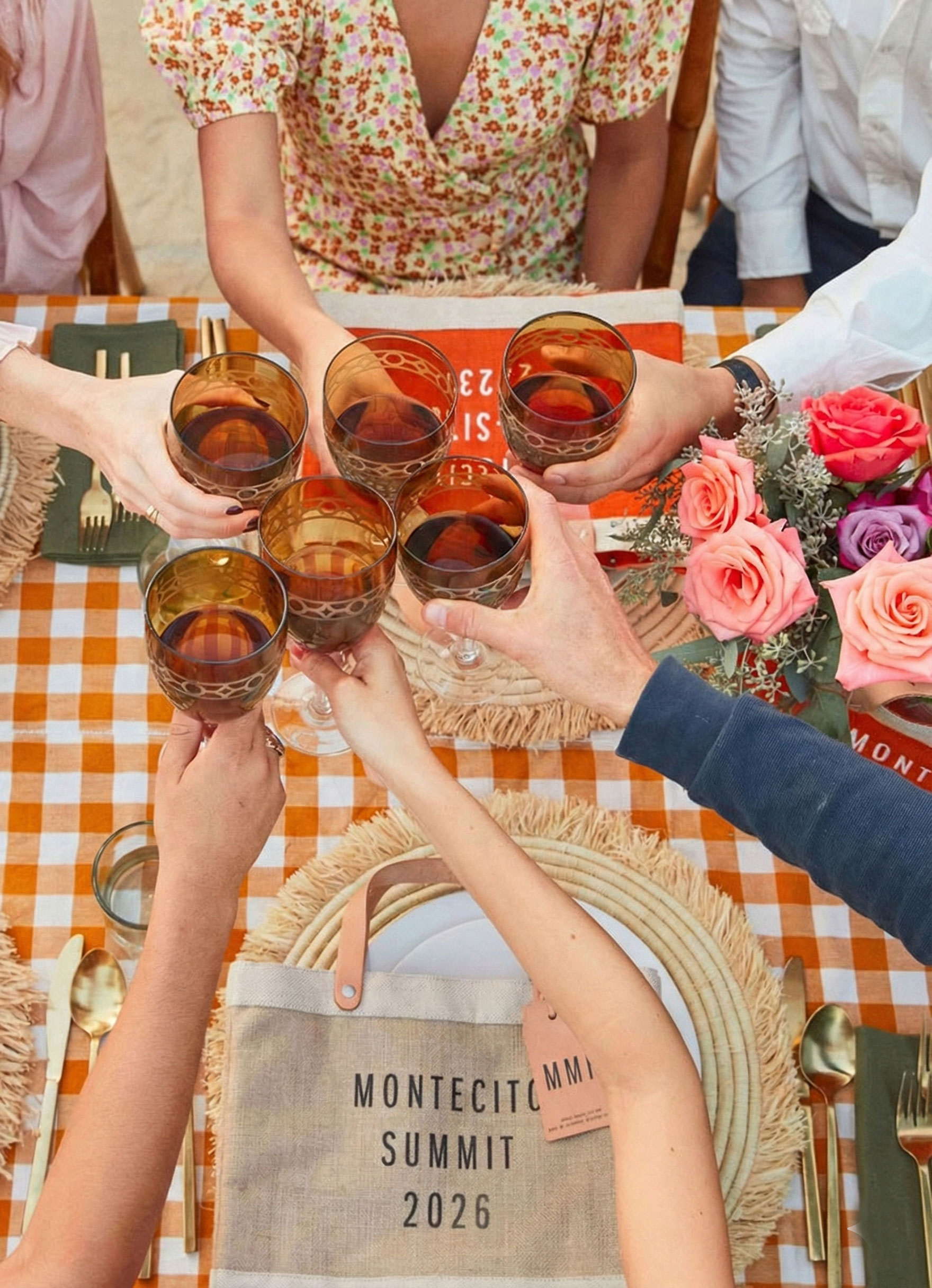 People sitting on a table enjoying friends with a market bag in front of them