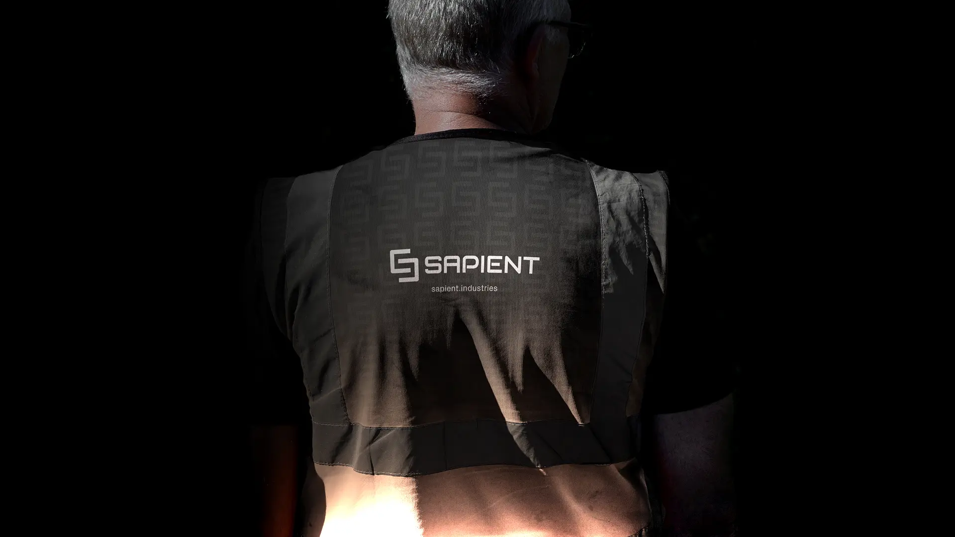 Sapient Industries branded work vest with the logo and sapient.industries on the back