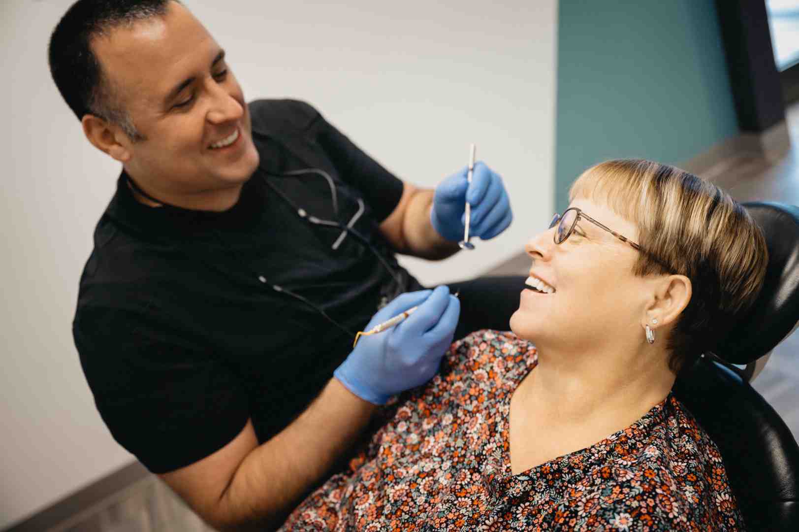 A person smiling comfortably in a dental chair, indicating a positive dental experience - dental root canal