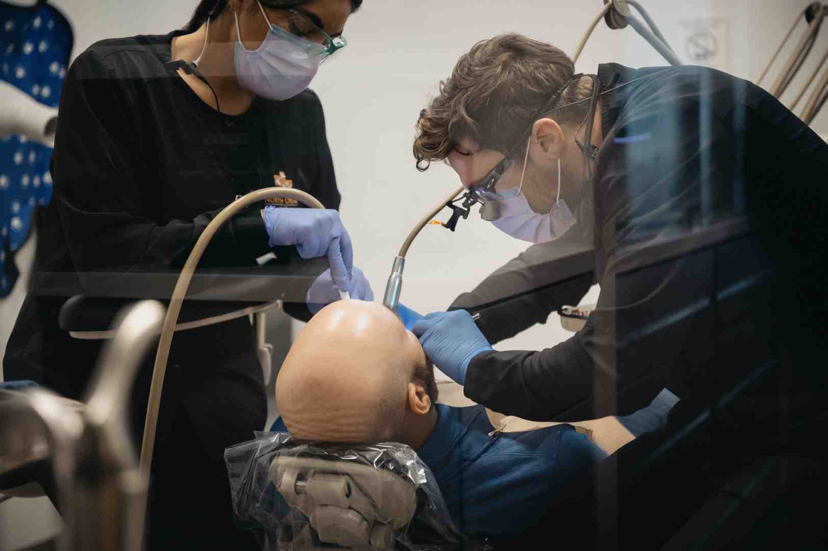 image of a dentist applying a treatment to a patient's teeth - Sensitive teeth treatment