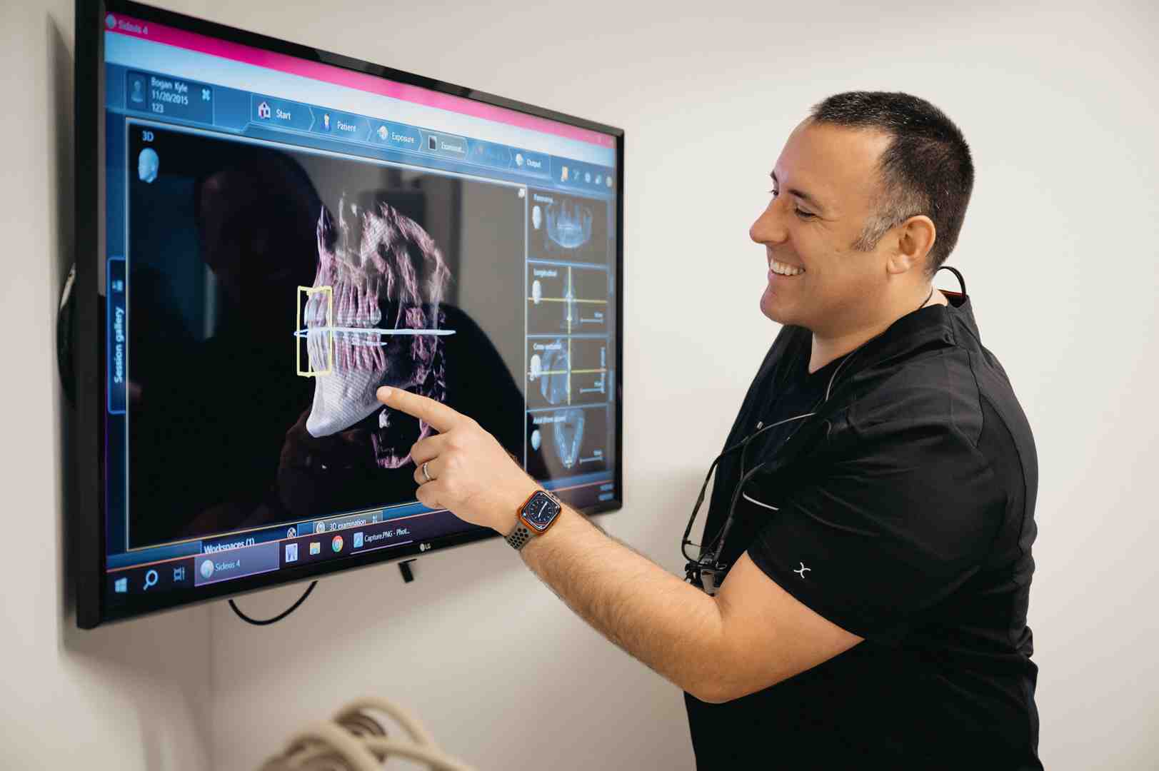 dentist and young patient reviewing smile design on screen - veneers for young adults dentist and young patient reviewing smile design on screen - veneers for young adults