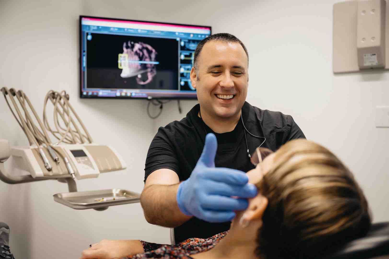 dentist and patient reviewing a tablet with a smile design - dental wellness plan ohio dentist and patient reviewing a tablet with a smile design - dental wellness plan ohio