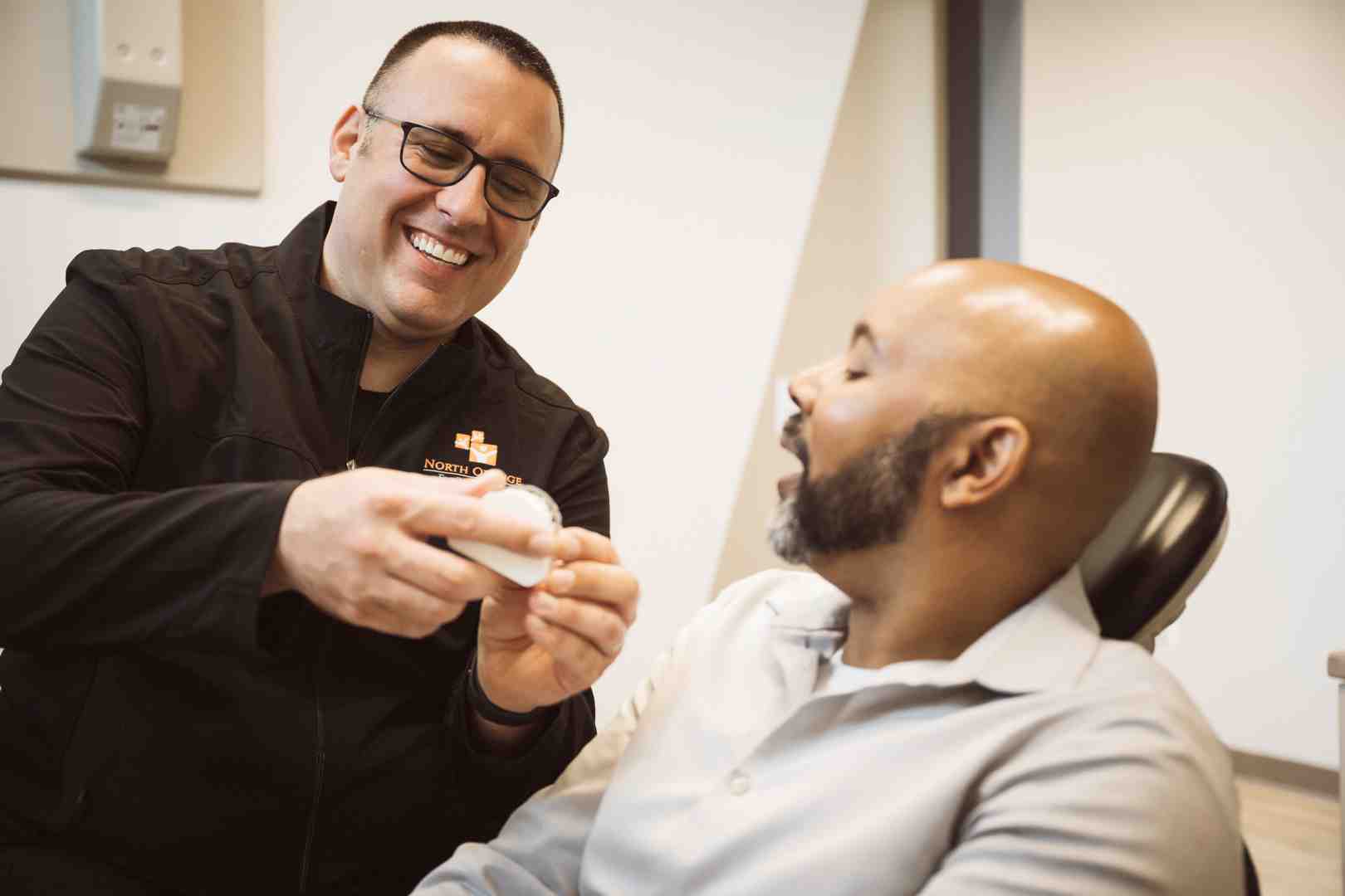 Dental professional explaining root canal aftercare to a patient - recovery after root canal