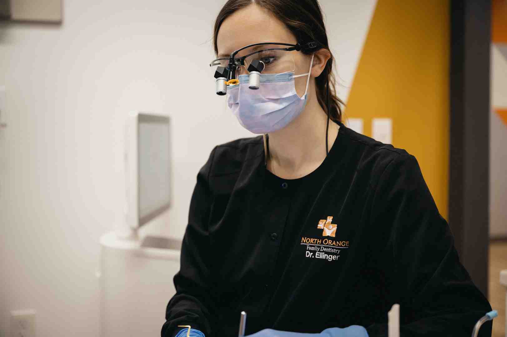 Dentist using a modern dental laser for TMJ and gum treatment - dental family