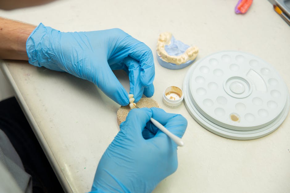 Detailed view of a dental implant post and abutment being prepared for a crown - cheapest dental implants prices near me